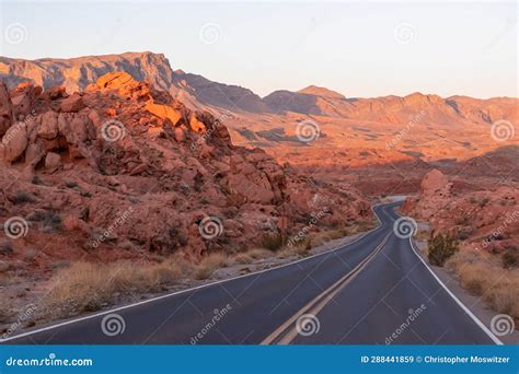 Valley Of Fire Panoramic Sunrise View Of Endless Empty Road Leading To Red Aztec Sandstone