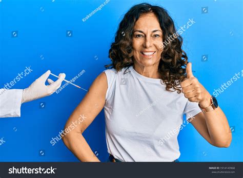 Middle Age Hispanic Woman Getting Vaccine Stock Photo 1914143968