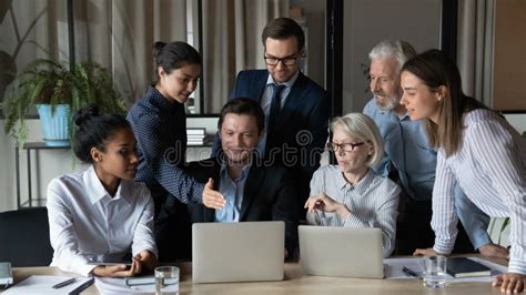 Diverse Employees Team Working On Online Project Using Laptops