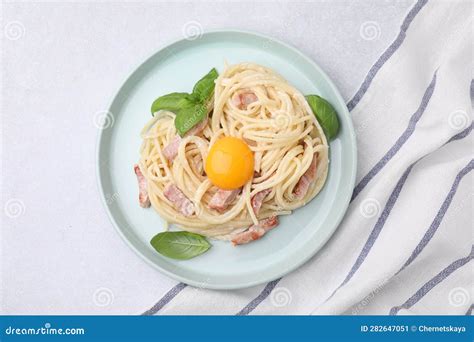 Delicious Pasta Carbonara With Egg Yolk On White Table Top View Stock