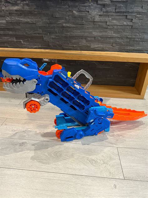 TOR SAMOCHODOWY wyścigowy Hot Wheels Zestaw T Rex Mega Transporter