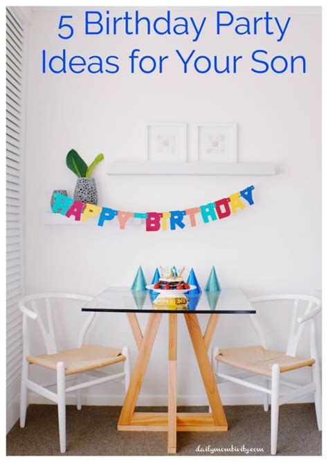 a birthday banner hanging over a table with two chairs and a cake on the table