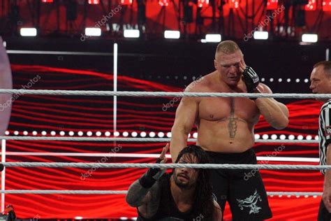 WWE Champion Brock Lesner Holds Face As He Grabs Roman Reigns Wh