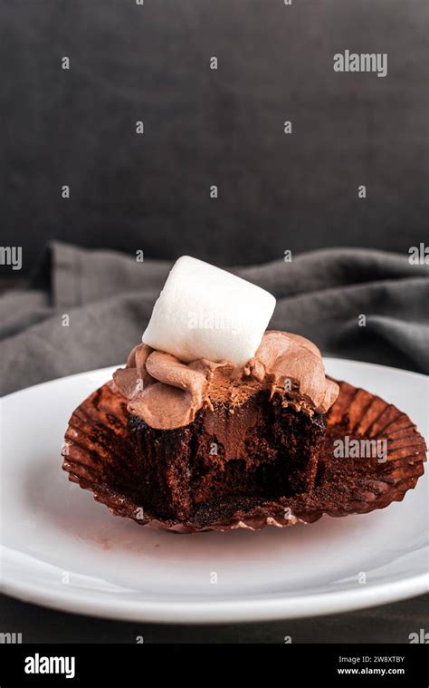 Hot Cocoa Cupcake With A Bite Taken Out Hot Chocolate Cupcake With Chocolate Ganache Filling