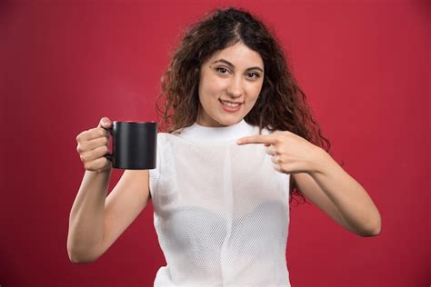 Free Photo Woman Holding Hot Dark Cup On Red