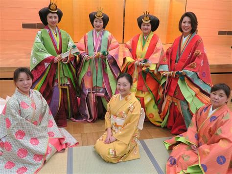 Women Dressed In Junihitoe Along With Another In A Modern Kimono At