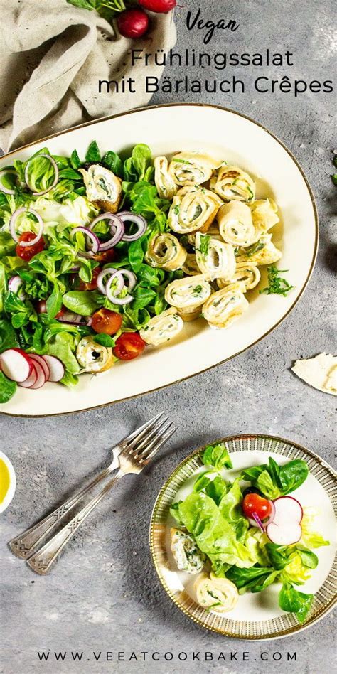 A Salad With Spinach And Onions On A Plate Next To A Bowl Of Dressing