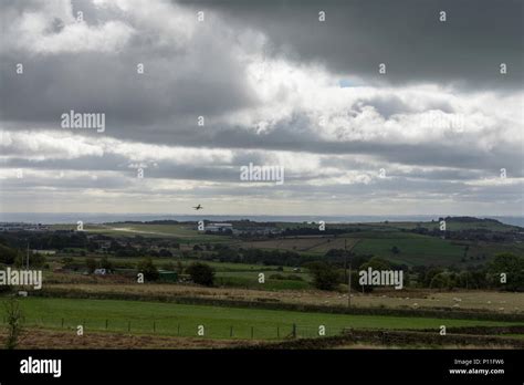 Plane Taking Off From Leeds Bradford Airport Heading Into A Storm Stock