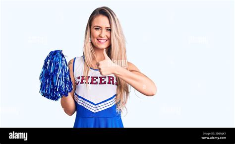 Young Beautiful Blonde Woman Wearing Cheerleader Uniform Holding Pompom