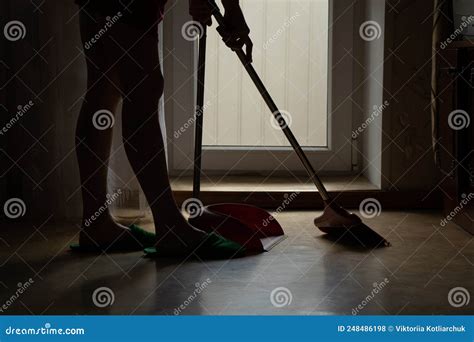 The Girl Sweeps The Floor Of The House With A Broom And The Scoop