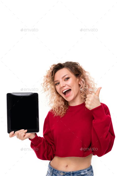 Emotional Caucasian Girl With Curly Fair Hair Shows A New Tablet And