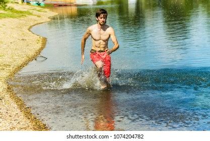 Naked Man Running On The Beach Shutterstock