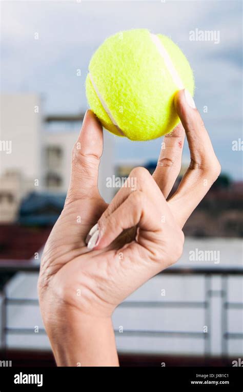 Woman S Hand Holding Tennis Ball Stock Photo Alamy