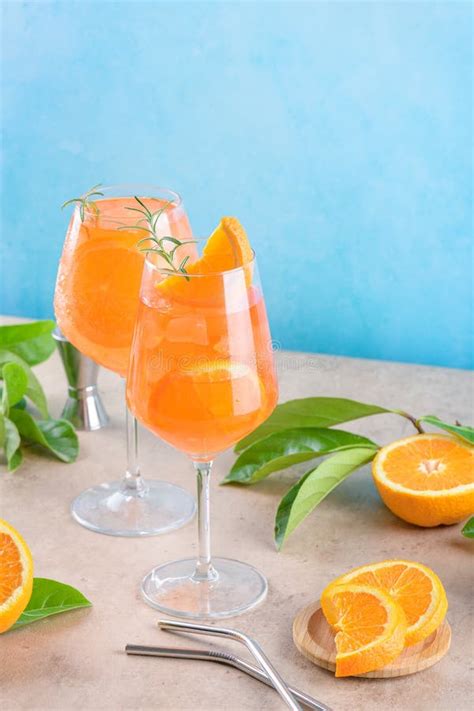 Classic Italian Aperitif Aperol Spritz Cocktail In Two Glass With Ice Orange On Blue Background