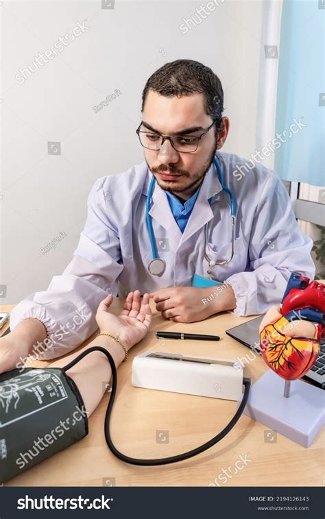 Doctor Checking Patient Arterial Blood Pressure Stock Photo 2194126143