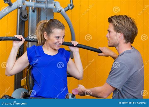 Gym Trainer Assisting Amateur Gym Goer Stock Photo Image Of Strength Position 268744144