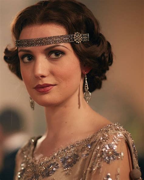 A Woman Wearing A Tiara And Jewelry In A Formal Dress Looking At The Camera