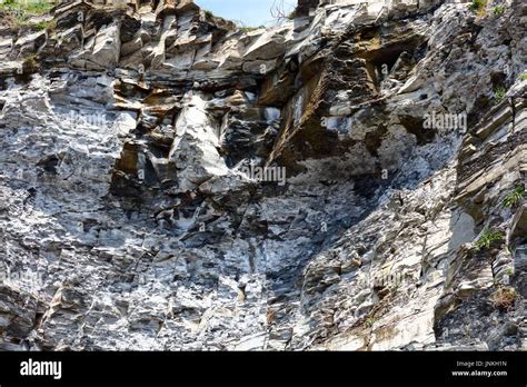 Geological Cliff Structures With Limestone And Soft Crumbling Oil