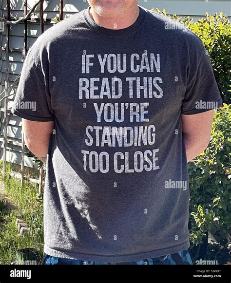 Man Dressed Casually Wearing A Snarky And Humorous T Shirt That Warns