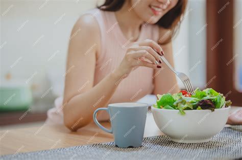 Premium Photo Cropped Shot Of Happy Woman Eating Fresh Vegetable