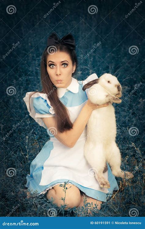 Funny Girl Costumed As Alice In Wonderland With The White Rabbit Stock