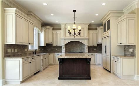 Kitchen with antique white cabinets and dark brown center island with ...