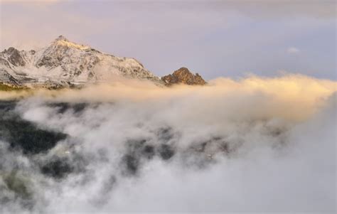 Premium Photo | Mountain in clouds at sunset