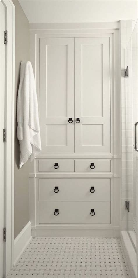 A White Bathroom With Black And White Floor Tiles On The Walls