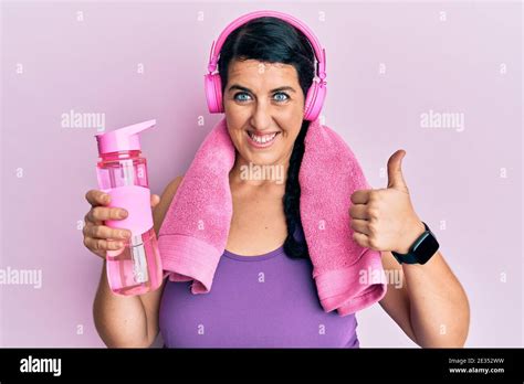 Plus Size Brunette Woman Wearing Sportswear Holding Water Bottle Smiling Happy And Positive