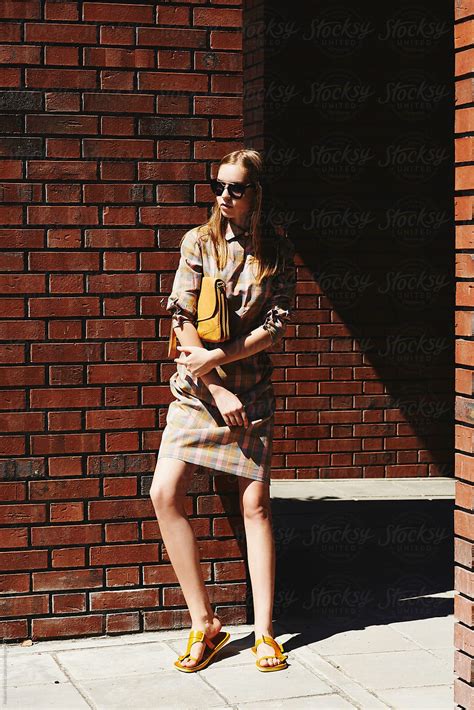 Blonde Girl Posing Against Brick Walls By Stocksy Contributor Atakan