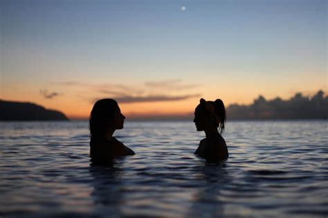 Free Stock Photo Of Silhouettes Of Two People In Water At Dusk