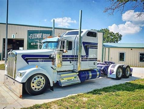 A Large Semi Truck Parked In Front Of A Building