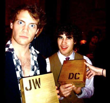 Two Men Holding Up Wooden Signs With The Letters Jw And Jw On Them