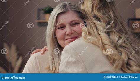 Happy Loving Elderly Mature Woman And Adult Daughter Laughing Embracing