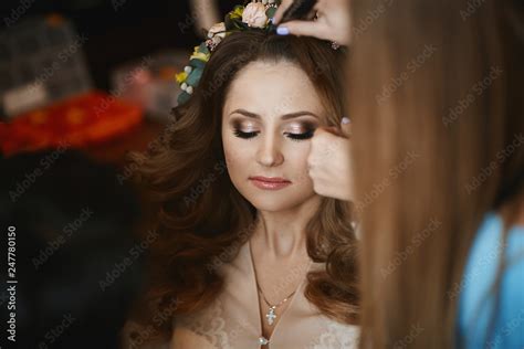 A Makeup Artist Applies Bright Wedding Makeup For The Beautiful Brunette Model Girl With Stylish