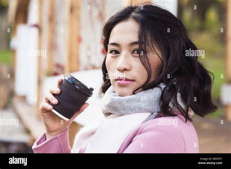 Girl Holding Paper Cup Of Hot Drink Stock Photo Alamy