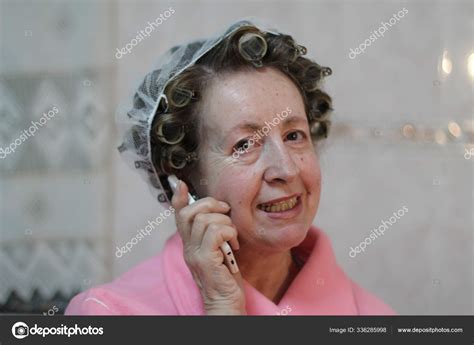 Close Portrait Mature Woman Hair Curlers Pink Bathrobe Talking Phone