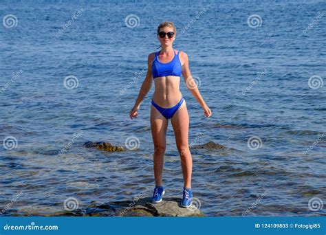 Una Muchacha Hermosa En Un Bikini Azul Camina El Embarcadero Al Mar