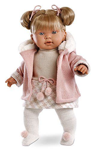 The Doll Is Wearing A Pink Coat And White Pants With Her Hands In Her