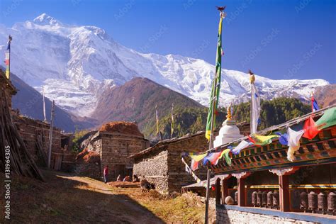 Upper Pisang Village Buddhist Praying Wall With Wheels And Flags And