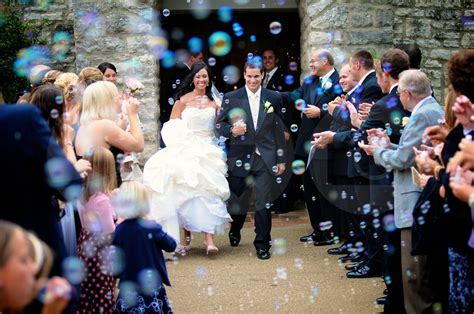 Wedding Photos Bride And Groom Making An Exit With Bubbles