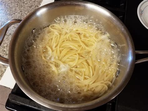 Pot Of Spaghetti Noodles In Boiling Water On Stove Stock Image Image