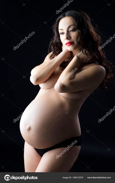 Portrait Of A Beautiful Pregnant Woman In Black Lingerie Studio On A Black Background Stock
