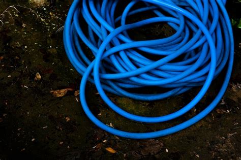 Premium Photo The Blue Plastic Water Pipe Placed On Wet Floor After