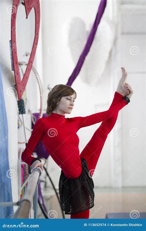 Elegant Gymnast Doing Stretching With Barre In A Studio Stock Photo