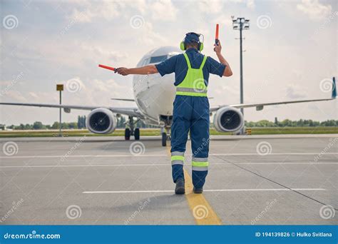 Man Signaling The Pilot With Marshalling Wands Stock Photo Image Of