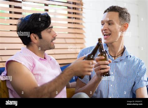 LGBTQ Gay Couple Doing Activities Together At Home And Socializing Together Happily Stock Photo