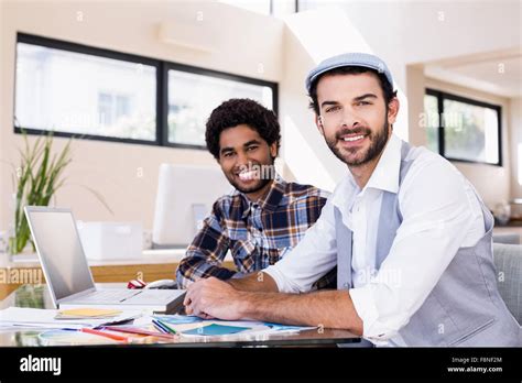 Portrait Of Smiling Gay Couple Using Laptop Stock Photo Alamy