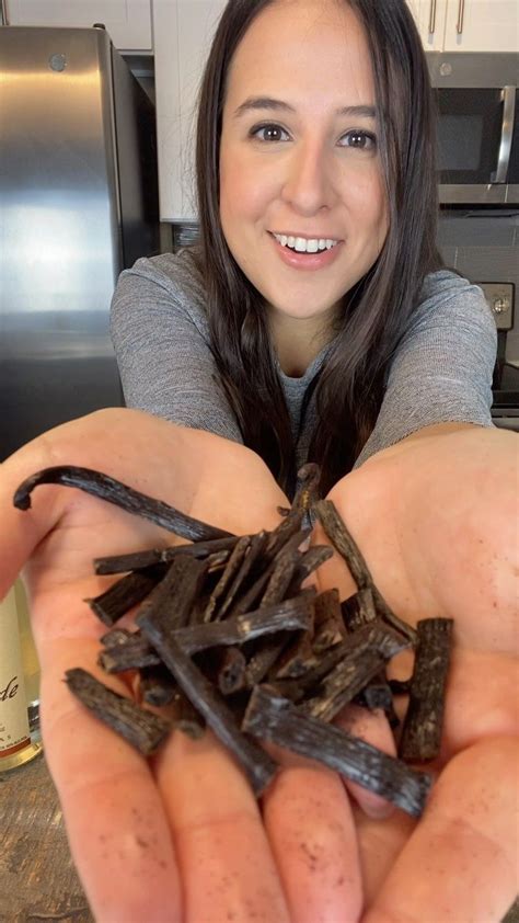 A Woman Is Holding Out Her Hands Full Of Wood Shavings In The Kitchen