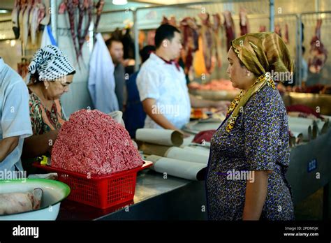 An Uzbek Woman Selling Minced Beef At The Colorful Butcher Market In